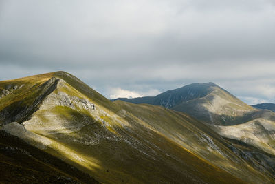 Scenic view of mountain range against sky in montemonaco, marche italy