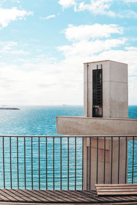 Building by sea against sky