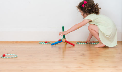 Girl playing on table at home