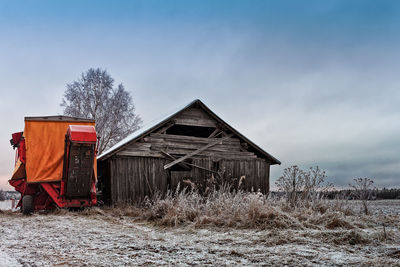 Abandoned house on field against sky