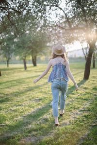 Woman with arms raised on field