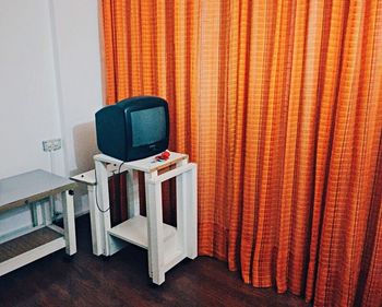 Empty chairs and table against wall at home