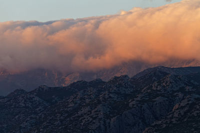 Scenic view of clouds above velebit  mountains against sky during sunset