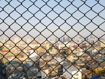 Full frame shot of chainlink fence against sky