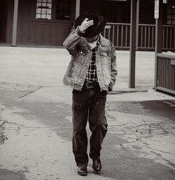 Rear view of woman standing on street