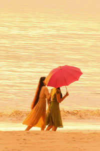 Woman with umbrella on beach