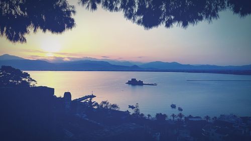 Boats in lake at sunset