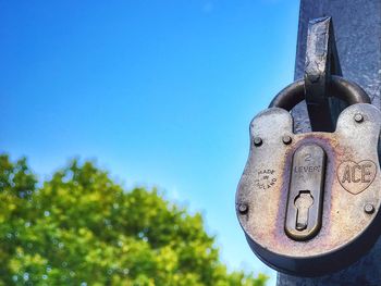 Close-up of padlock against blue sky