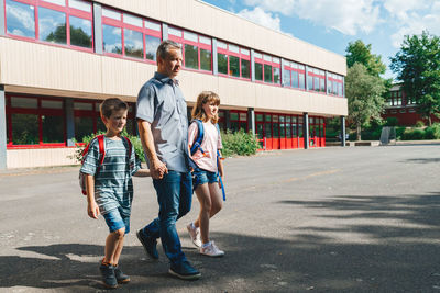 Dad accompanies or picks up children from school. beginning of the school year