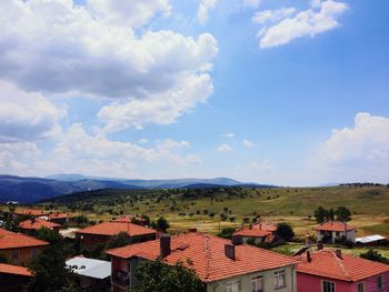 High angle view of houses against cloudy sky