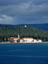 Scenic view of sea and buildings against sky