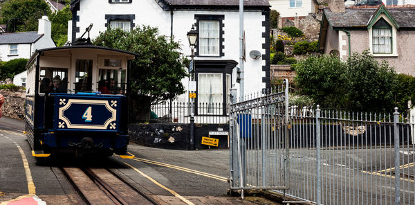 Train on railroad tracks by buildings in city