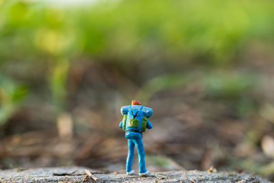 Miniature people backpackers walking with friends 