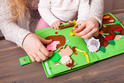 High angle view of baby playing with toy on table