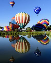 Multi colored hot air balloons flying against sky