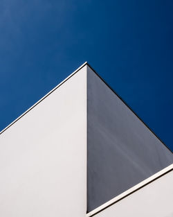 Low angle view of building against clear blue sky