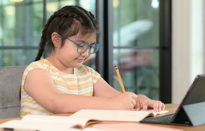 Young woman using laptop at home