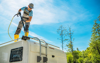 Low angle view of man skateboarding on field