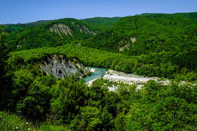 Scenic view of green mountains against sky