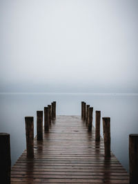 Pier over sea against clear sky