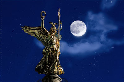 Low angle view of statue at victory column against full moon