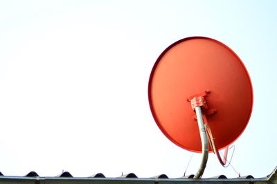 Satellite dish on rooftop against clear sky