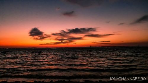 Scenic view of sea against romantic sky at sunset