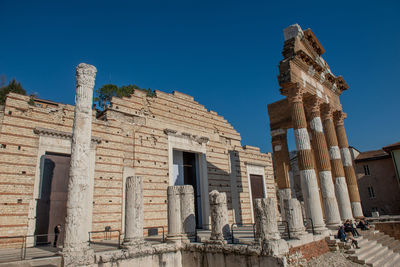 Low angle view of old building against clear blue sky