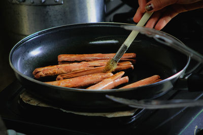 Close-up of person preparing food in kitchen