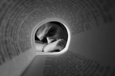 Close-up portrait of man reading book