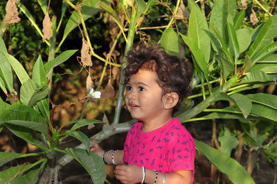 Portrait of cute girl with pink plants