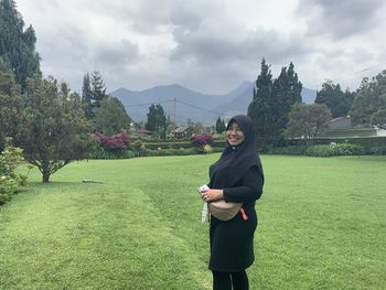 Full length of woman on field against sky