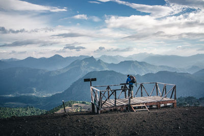 Scenic view of field and mountains against sky