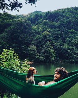 View of dog in the hammock with his friend