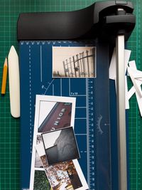 Directly above shot of photographs and measuring instrument on table