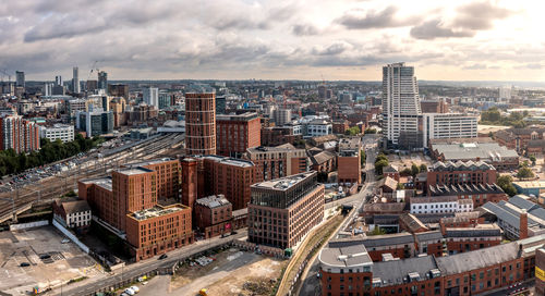 Aerial panoramic leeds cityscape skyline with granary wharf and bridgewater place skyscraper sunrise