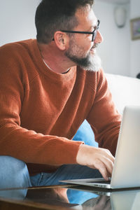 Young man using laptop while sitting at home