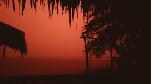 Silhouette palm trees against sky during sunset