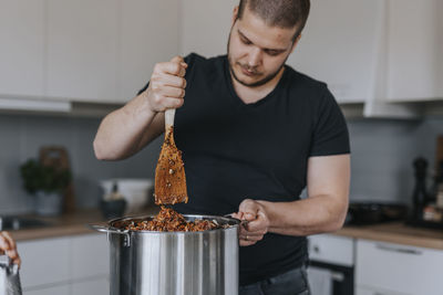 Man in kitchen preparing food