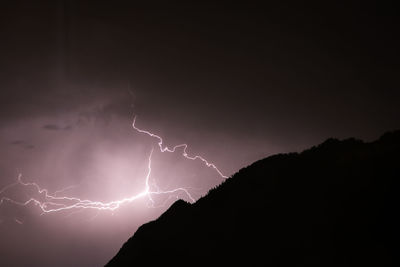 Low angle view of lightning in sky at night