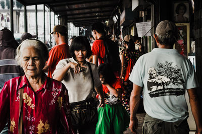 Rear view of people standing in corridor