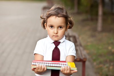 Portrait of cute girl standing in park