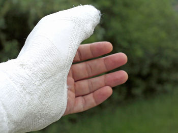 Cropped injured hand with plaster 