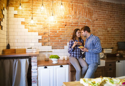 Romantic couple embracing at kitchen