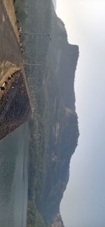 High angle view of sea and mountains against sky