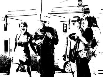 Silhouette people standing against sky on sunny day