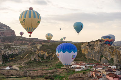 Hot air balloons flying over mountain