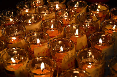 High angle view of burning tea lights