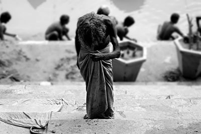 High angle view of man standing on steps by ganges river