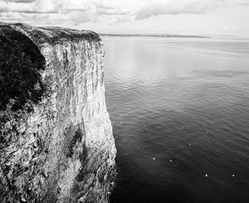 High angle view of rocks in sea against sky